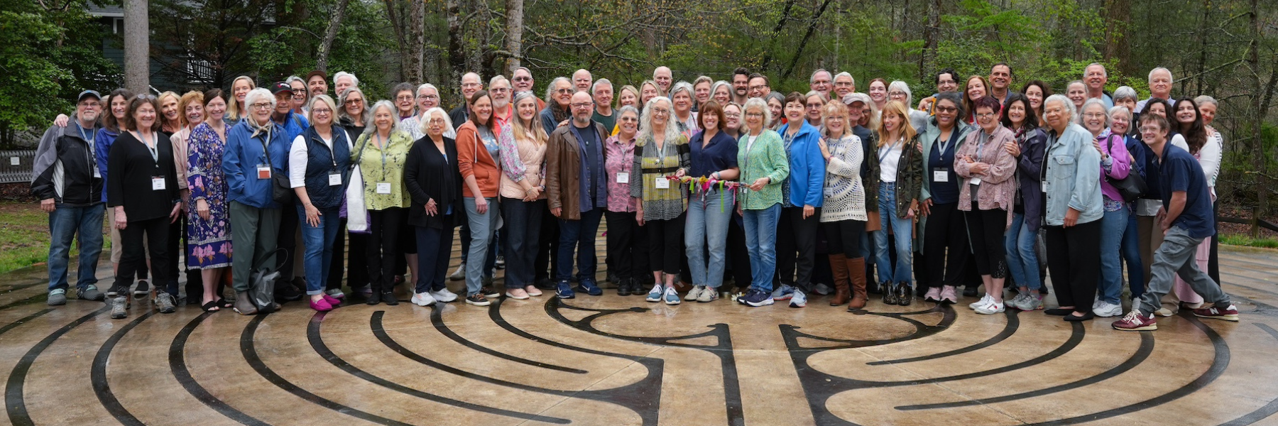 A large group photo of spiritual direction and dream work trainers and students from the Haden Institute gathered on the labyrinth at Kanuga Conference Center.