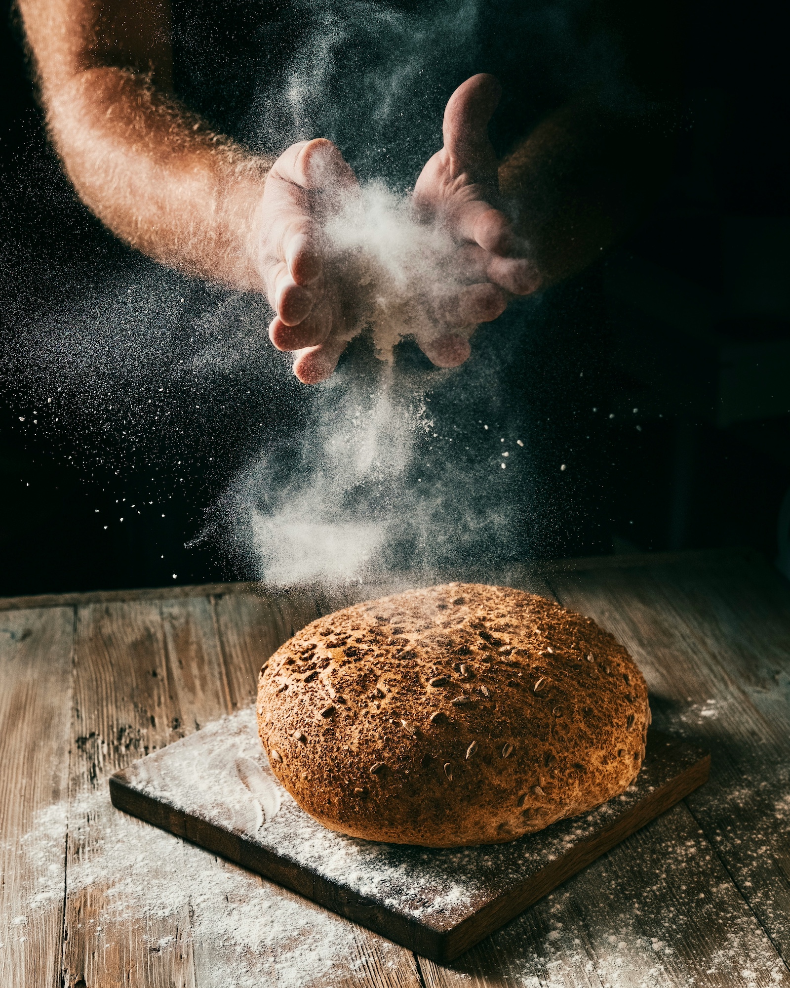 Hands raised in blessing over bread